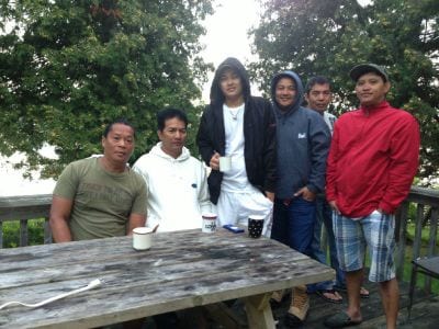 Guests gathered around the picnic table at Sandbanks Cottages